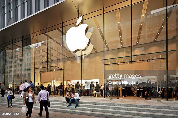 Shanghai, China - October 12, 2011: Glass entrance to the Apple Store at Nanjing road opened on the September 23, 2011. Many people inside and outside the shop.
